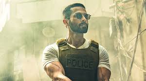 Shahid Kapoor in an action scene from "Deva", wearing a Police vest and sunglasses