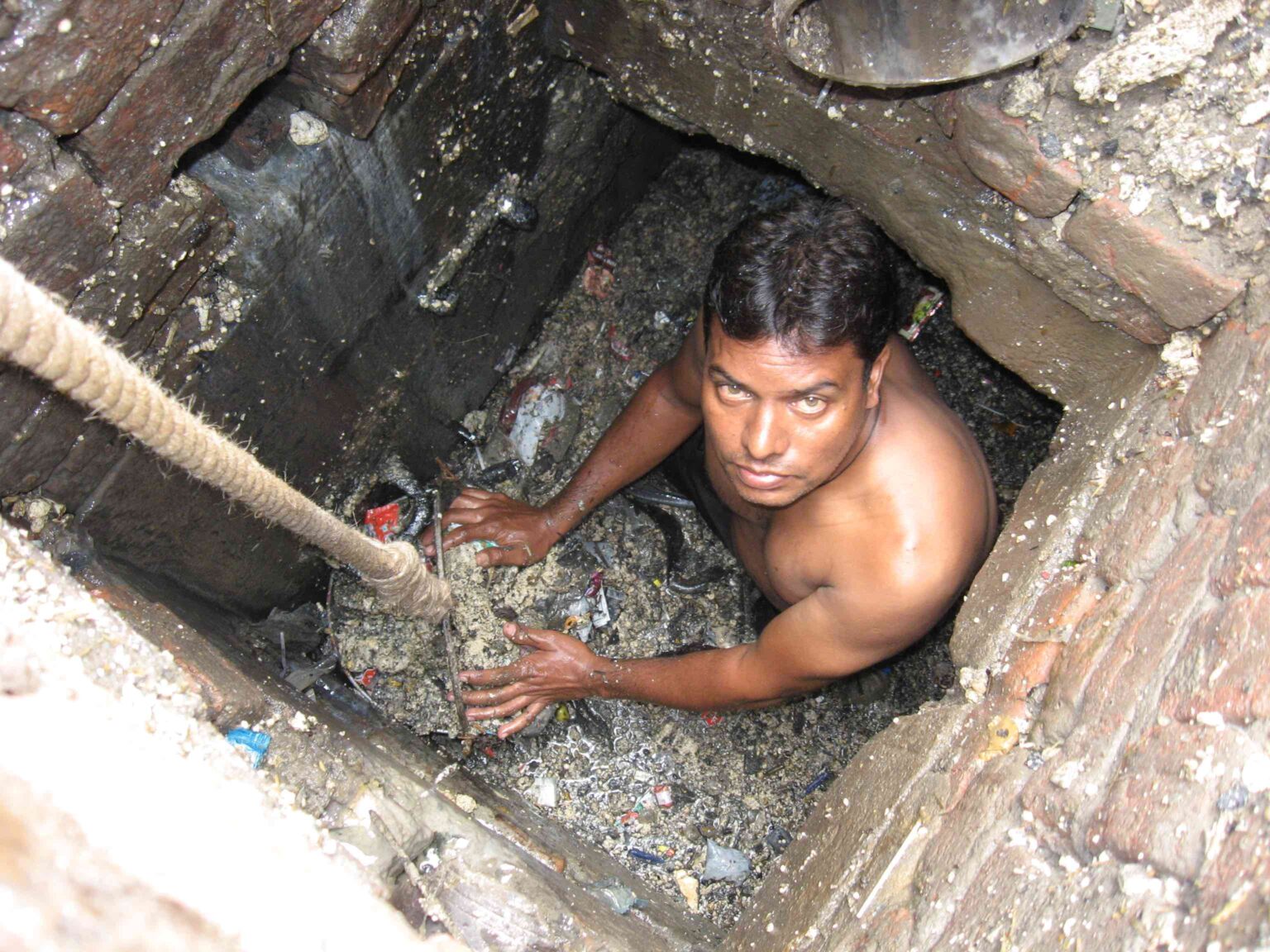 sanitation worker inside the gutter