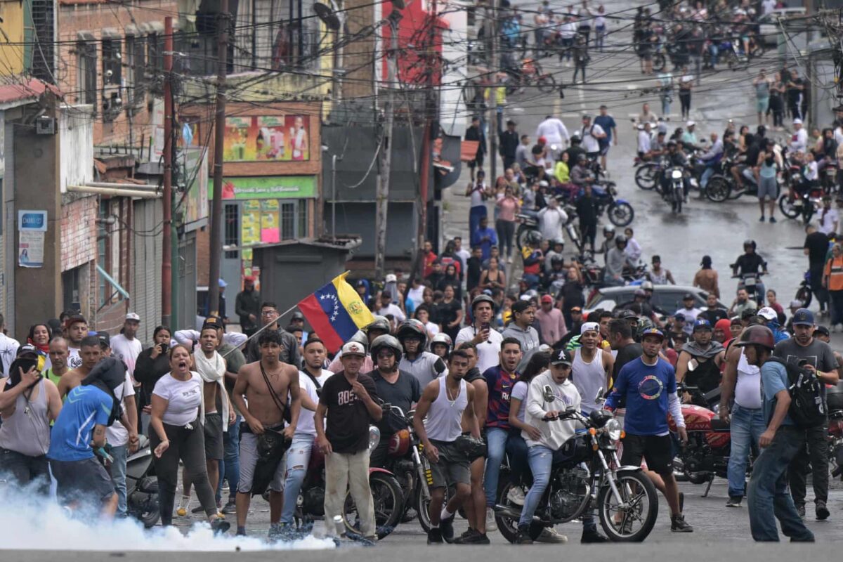 A canister of teargas lands in front of demonstrators during a protest against President Nicolás Maduro’s government in Caracas. Photograph by Yuri Cortéz/AFP/Getty Images.