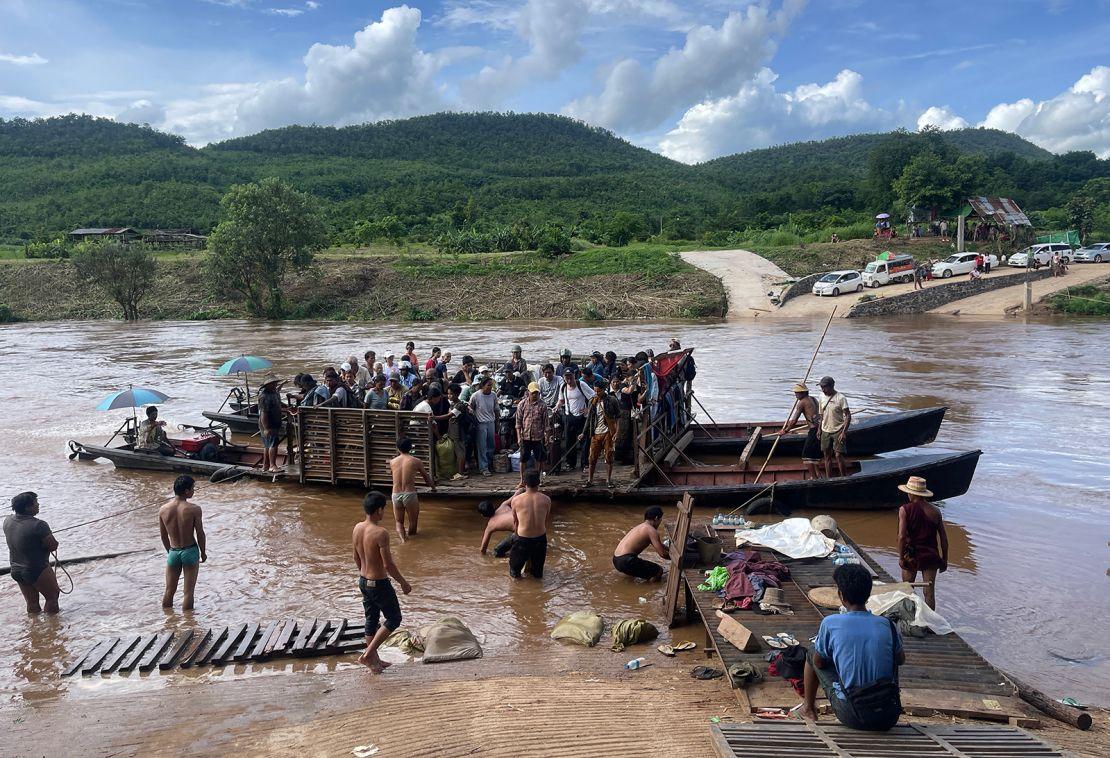 Displaced people cross the Dokhtawaddy river at Zin Ann village, between Lashio and Hsipaw township in Myanmar's northern Shan state, on July 8, 2024