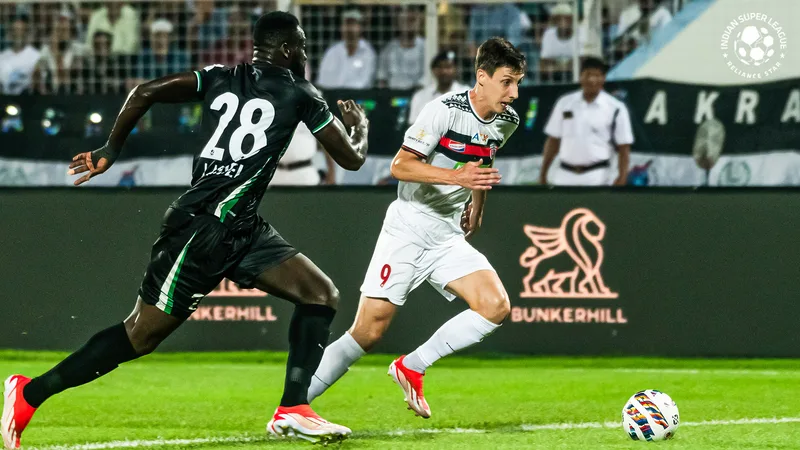 Northeast United Guillermo Fernández tries to find his way through Mohammedan's Joseph Adjei in ISL