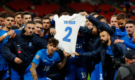 The Greece players celebrate their country’s first win against England by paying tribute to George Baldock on the Wembley pitch in Nations League