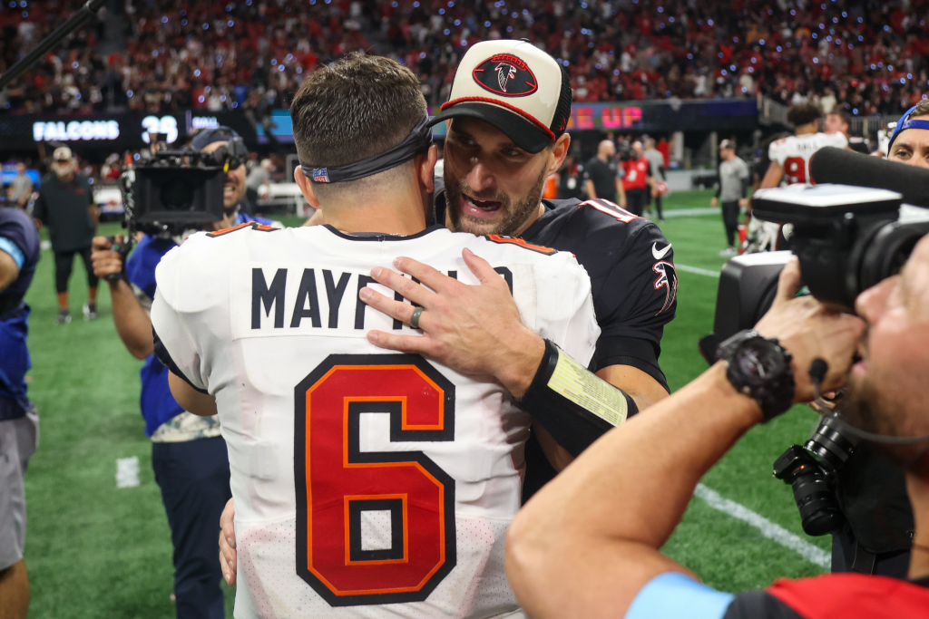 Atlanta Falcons quarterback Kirk Cousins (18) talks to Tampa Bay Buccaneers quarterback Baker Mayfield (6) after a game at Mercedes-Benz Stadium in the NFL