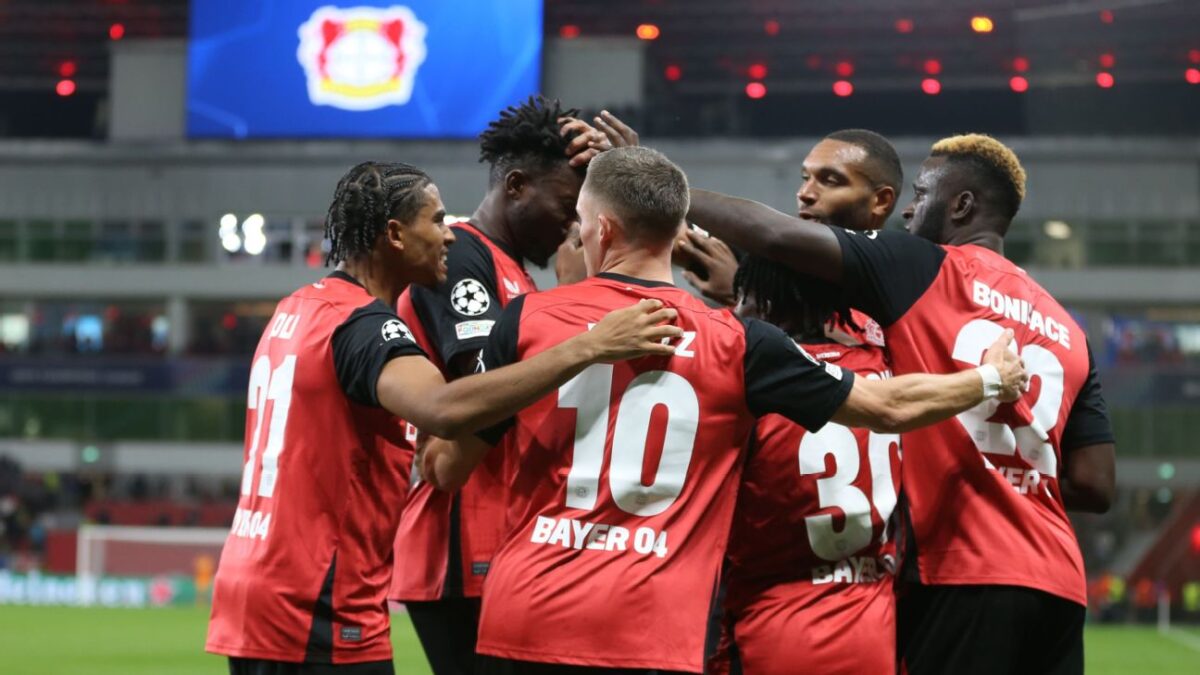 Bayer Leverkusen players celebrate after scoring a goal against Milan in the UCL 2024-25