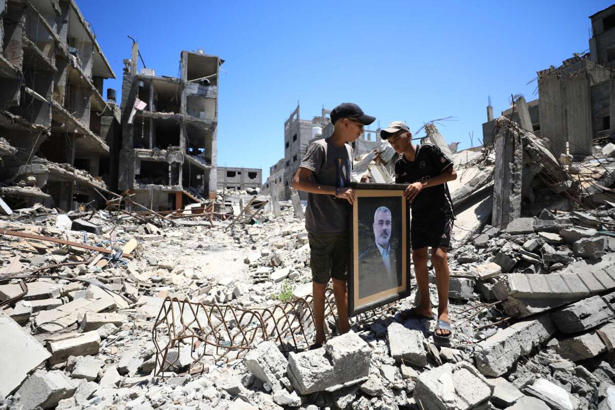 Palestinian children carrying a photo of Ismail Haniyeh.