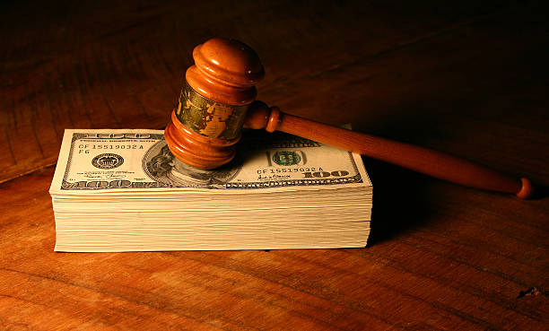 Used gavel on a stack of money.