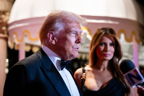 PALM BEACH, FLORIDA - DECEMBER 31:  U.S. President-elect Donald Trump and his wife Melania Trump arrive on New Year's Eve at his Mar-A-Lago Club on December 31, 2024 in Palm Beach, Florida. Trump continues to fill posts in his upcoming administration ahead of his January 20 inauguration.