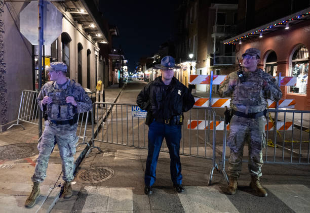 Members of the National Guard and police look on at a blocked off street, a block from Bourbon Street, after at least 15 people were killed during an attack early in the morning on January 1, 2025 in New Orleans, Louisiana. A US army veteran with an Islamic State flag and "hellbent" on carnage steered a pickup truck into a crowd of New Year revelers in New Orleans on January 1, killing at least 15 people and wounding dozens, officials said. The FBI identified the attacker as Shamsud-Din Jabbar, a 42-year-old US citizen from Texas. 